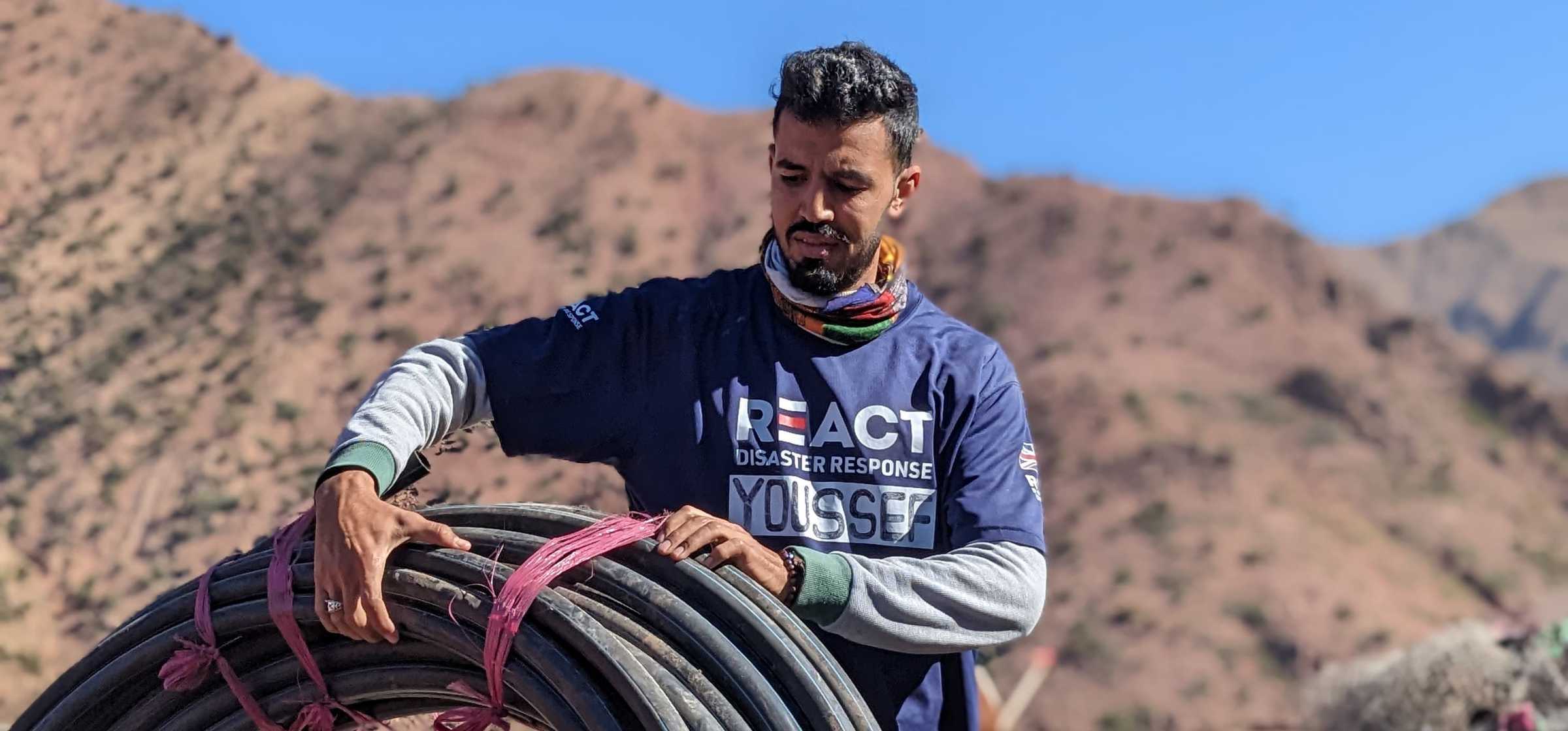 Youssef unloading 300m of water piping for the village of Alfalkou (Annfarkou) 02.jpeg