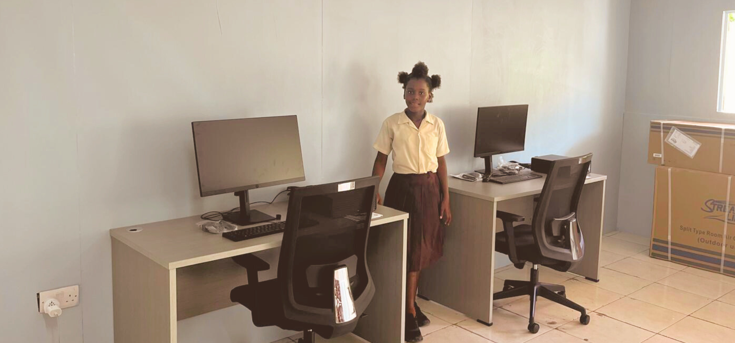 Shanika with SLT ICT Packages at Canouan Primary_Kirsten Edmonds.png